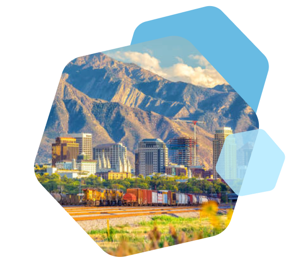 Utah cityscape with mountains and train transporting freight
